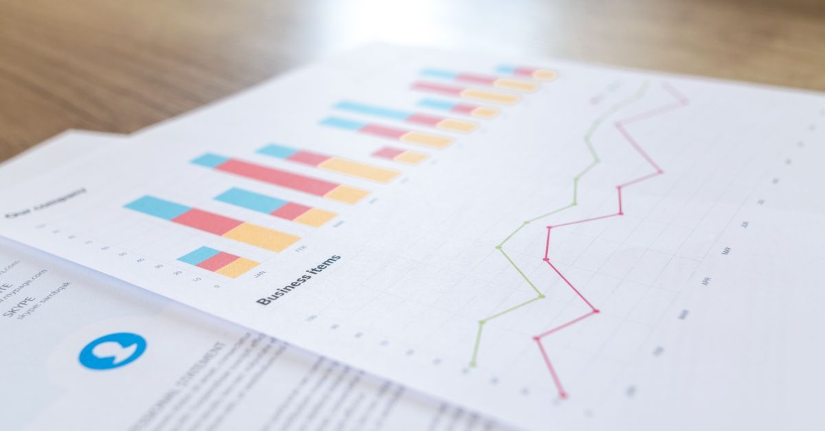 Printed bar and line charts of financial projections on a desk