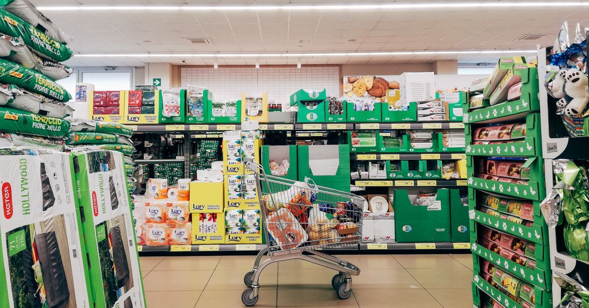 A shopping cart in a supermarket aisle