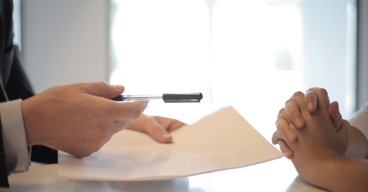 Two people reviewing an application across a desk